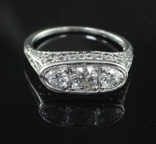 A 1950s/1960s platinum and three stone diamond ring, size M.
